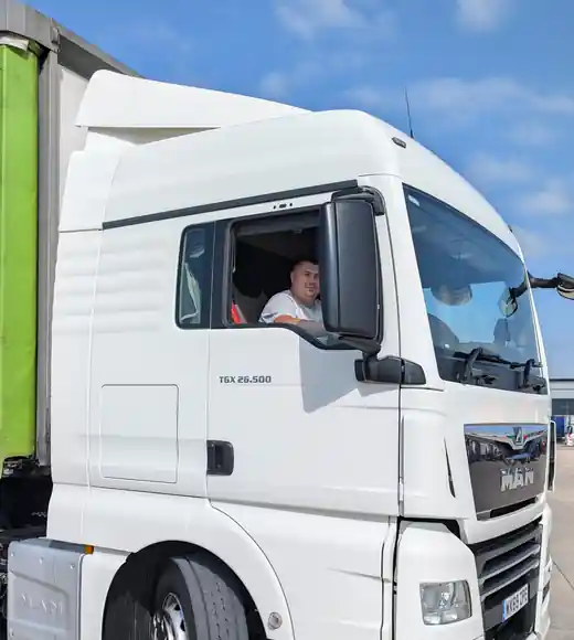 SL Transport Logistics driver in the cab of a MAN TGX 26.500